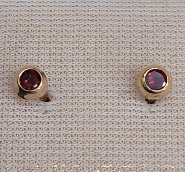 Handmade 14 carat gold stud earrings Garnets stones faceted round shape set in bezel setting. Dimension diameter 0.3 cm approximately.