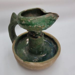 Genuine antique Islamic green glazed pottery lamp oil 10th century CE with green glazing and a massive handle. Dimension diameter 10 cm X 10 cm.