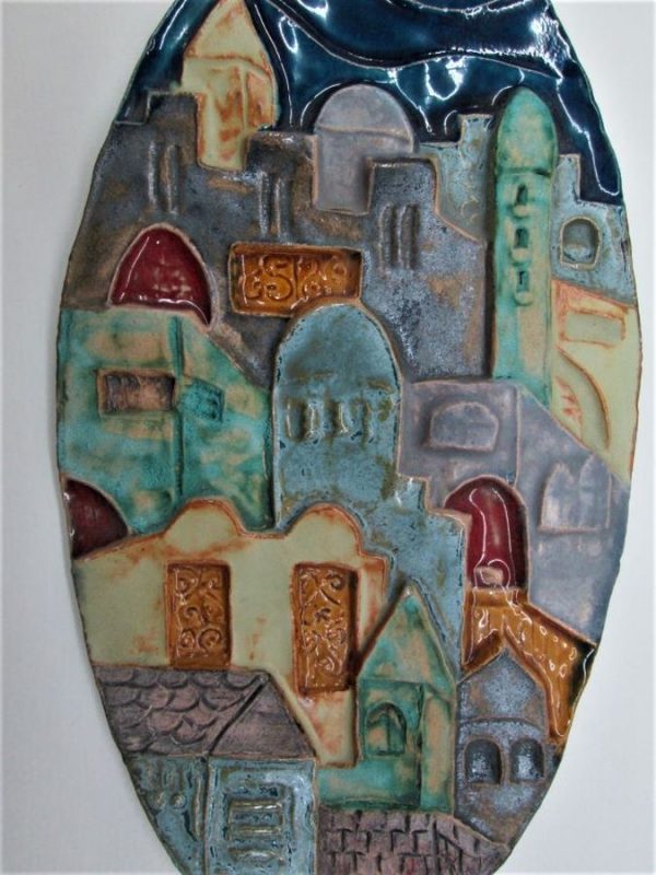 Handmade blue glazed ceramic Jerusalem houses oval tile with its different houses. Dimension 14.8 cm X 28 cm approximately.
