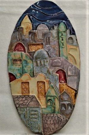 Handmade blue glazed ceramic Jerusalem houses oval tile with its different houses. Dimension 14.8 cm X 28 cm approximately.