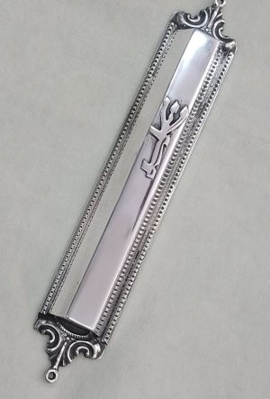 Handmade sterling silver Mezuzah trapeze shape with carvings on top and bottom of Mezuzah. Dimension 1.5 cm X 15 cm X 3 cm approximately. 