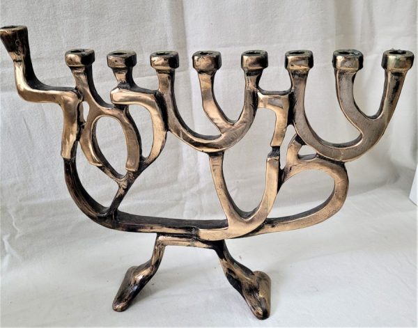 Handmade bronze SHEMA ISRAEL Hanukah Menorah , shaped contemporarily with the words SHEMA ISRAEL ( O' HEAR ISRAEL) in Hebrew.