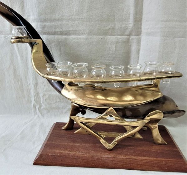 Hanukah Menorah shofar shaped made by Y. Eithan, each item he sculptures, is one of a kind. He does not repeat his designs.