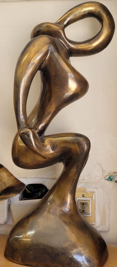 Handmade bronze sculpture lady exercising her muscles, described by artist in a fabulous abstract contemporarily design 37 cm X 14 cm X 11 cm approximately.