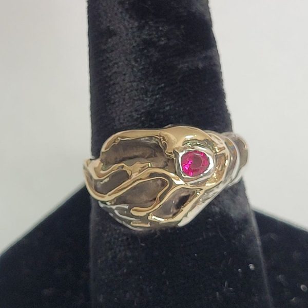 Original abstract genuine Ruby ring made with sterling silver and 14 carat gold and set with genuine red Ruby stone 1.5 cm X 1.2 cm approximately.