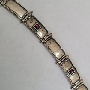 Handmade sterling silver hammered silver Garnets bracelet on each hammered silver bracelet link contemporary style with a cabochon cut Garnet stone.
