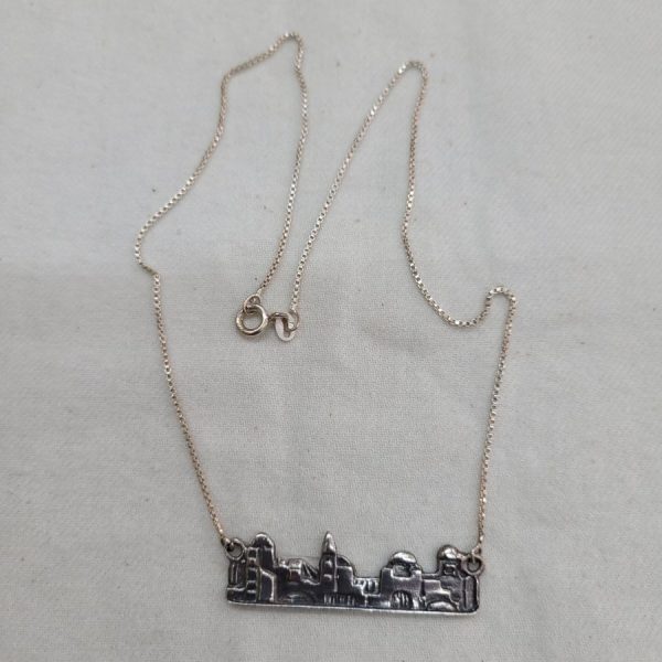 Handmade sterling silver Jerusalem skyline pendant with its houses and box chain. Dimension 3.8 cm X 1 cm X 0.1 cm approximately.