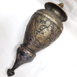 The engravings on vintage brass Purim ratchet Grogger handmade & hammered copper showing the preparation for the king's feast.