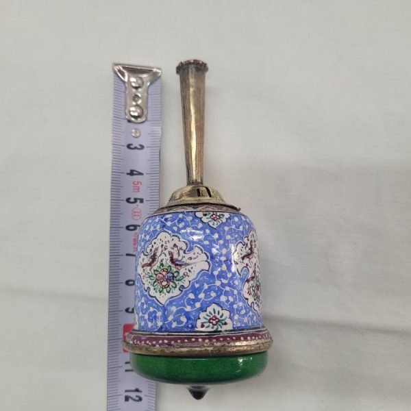 A combined handmade wood base and brass enameled Hanukah Dreidel hand painted floral & birds designs. Diameter diameter 4.2 cm X 12 cm approximately.