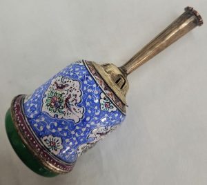 A combined handmade wood base and brass enameled Hanukah Dreidel hand painted floral & birds designs. Diameter diameter 4.2 cm X 12 cm approximately.