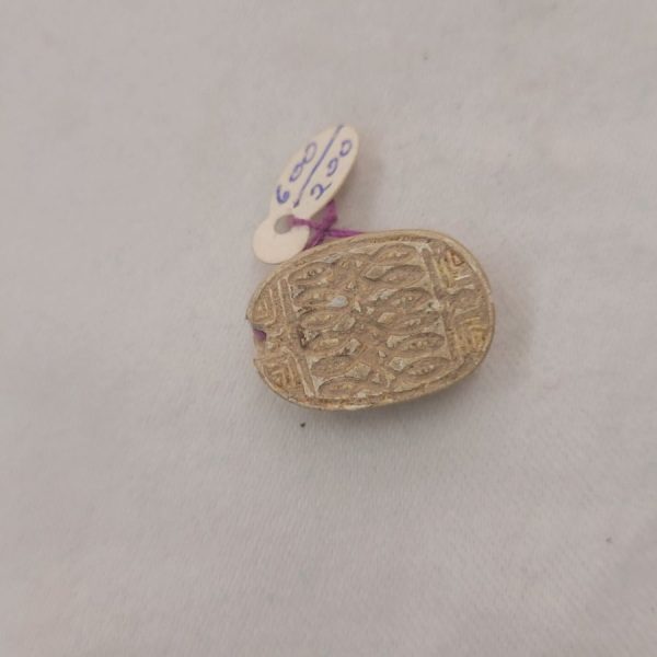 A genuine Egyptian Scarab cartouche with Hieroglyph writing mainly fish engravings dated 2nd century BC. Dimension 1.4 cm X 2.2 cm X 0.9 cm approximately.