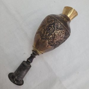 The engravings on vintage Purim Raashan Grogger brass are handmade & hammered brass showing different floral design and on top a brass bell.
