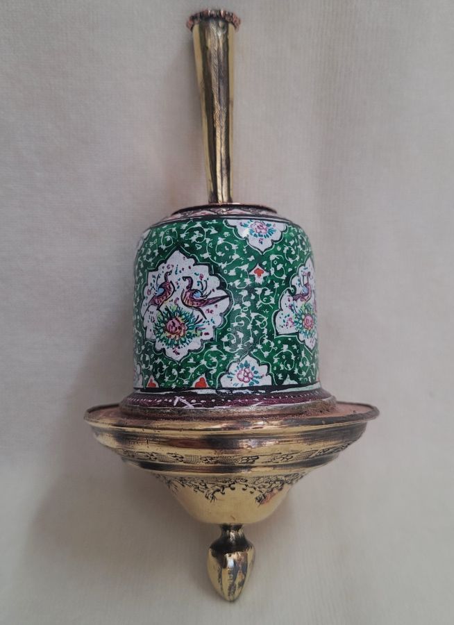 A combined handmade wood base and brass green enameled Hanukah Dreidel hand painted floral & birds designs diameter 5.6 cm X 12 cm.