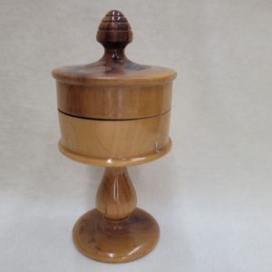 Havdalah olive wood box with Jerusalem houses hand painting designs on cover and has a stands. Dimension diameter 5 cm X 12 cm approximately.