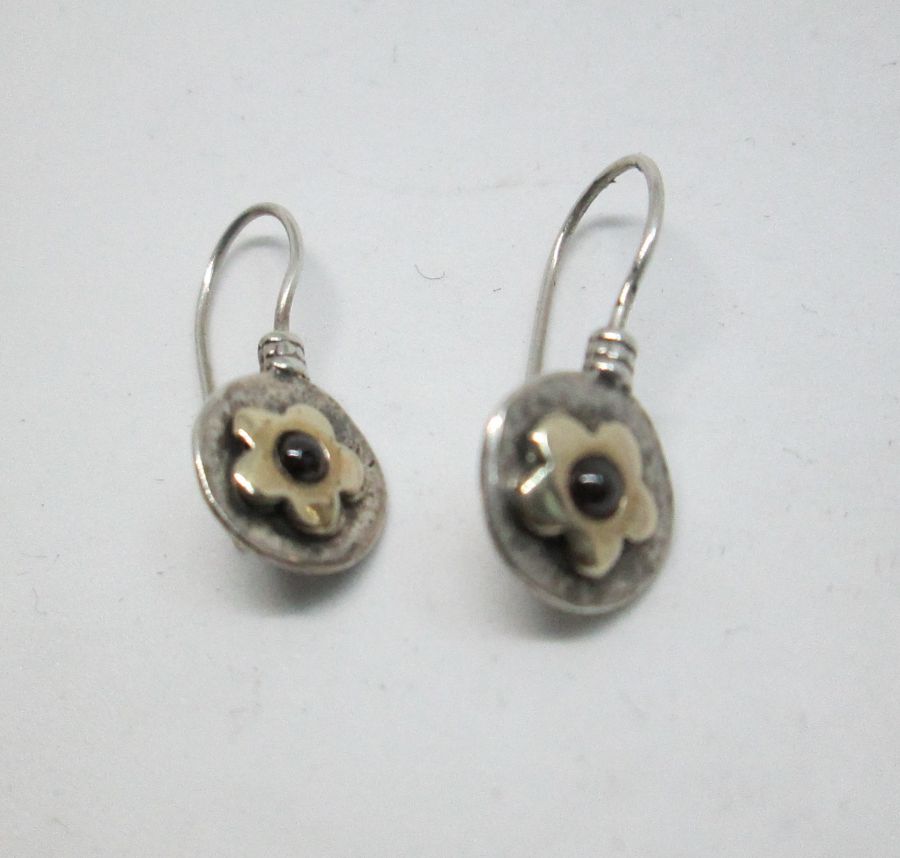 The hook in sterling silver and 14 carat gold flower Garnet earrings can not be changed to screw finding for non pierced ears.